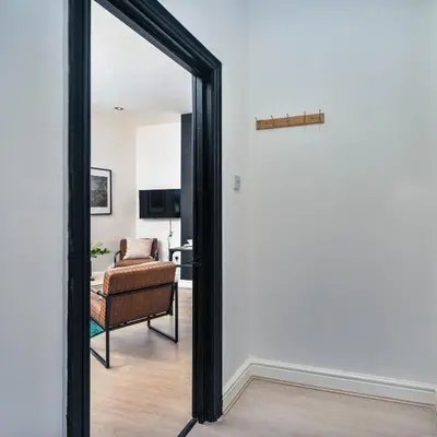 a mirror in a living room with a chair at Lombana Apt 4 - City Centre - Parking in Liverpool