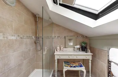 a bathroom with a shower and a sink and a tub at heft view at rose cottage - opp heft restaurant in Grange Over Sands