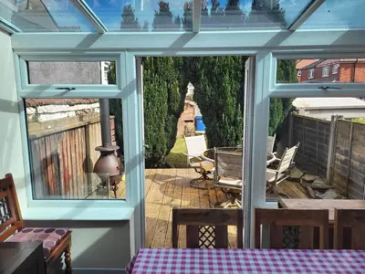 a screened in porch with a view of a patio at Cosy cottage in Chorley
