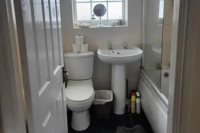 a small bathroom with a toilet and a sink at Cottage - Sleeps 4 - Garden - Parking in Chorley