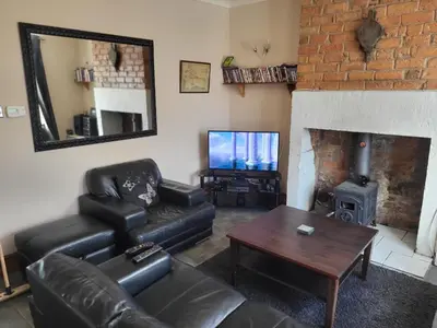 a living room with a couch and a fireplace at Cottage - Sleeps 4 - Garden - Parking in Chorley