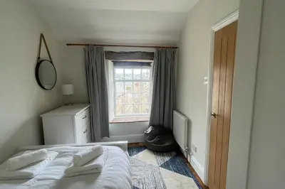 a bedroom with a bed and a window at 3 double bed whole house by castle in Lancaster