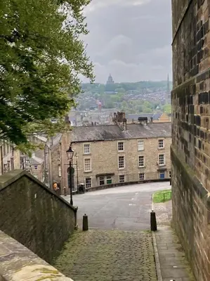 an empty street in a town with a building at 3 double bed whole house by castle in Lancaster
