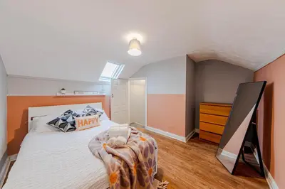 a bedroom with a bed and a dresser at Spacious 3-Bedroom Liverpool Home Sleeps 6 Great Transport Links in Liverpool