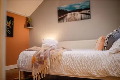 a bedroom with a bed with a blanket on it at Spacious 3-Bedroom Liverpool Home Sleeps 6 Great Transport Links in Liverpool