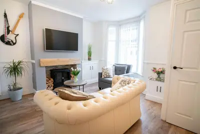 a living room with a couch and a fireplace at Moonlight Residence - Anfield Stadium, Free Parking & Free WiFi in Liverpool