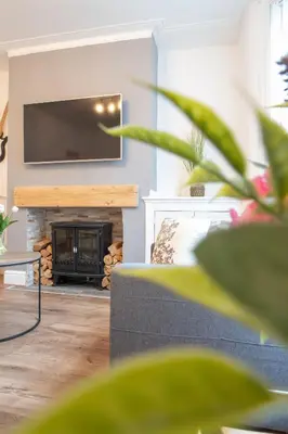 a living room with a couch and a fireplace at Moonlight Residence - Anfield Stadium, Free Parking & Free WiFi in Liverpool