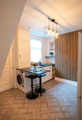a kitchen with a table in the middle of a room at Moonlight Residence - Anfield Stadium, Free Parking & Free WiFi in Liverpool
