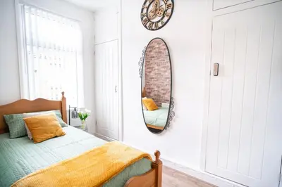 a bedroom with a bed and a mirror on the wall at Moonlight Residence - Anfield Stadium, Free Parking & Free WiFi in Liverpool