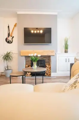 a living room with a fireplace and a tv at Moonlight Residence - Anfield Stadium, Free Parking & Free WiFi in Liverpool