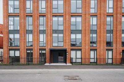 a brick building with a door in front of it at Richmond Row Apartments - Free On-Site Parking, WiFi & EV in Liverpool