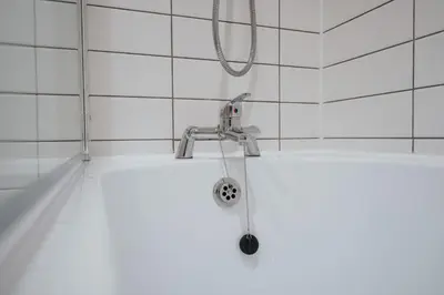 a bathroom with a shower head and a sink at Richmond Row Apartments - Free On-Site Parking, WiFi & EV in Liverpool