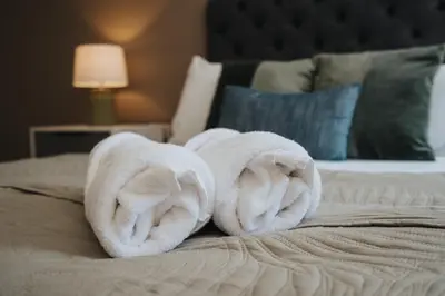 a bed with two towels on top of it at Richmond Row Apartments - Free On-Site Parking, WiFi & EV in Liverpool