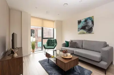 a living room with a couch and a chair at Richmond Row Apartments - Free On-Site Parking, WiFi & EV in Liverpool