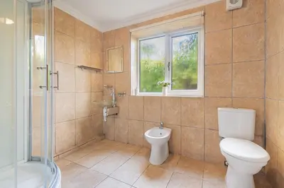 a bathroom with a toilet and a shower and a window at Bayview House Silverdale in Silverdale