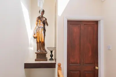 a statue of a woman standing next to a door at Bayview House Silverdale in Silverdale
