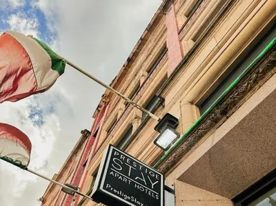 a building with a flag next to a street sign at Mathew Street 1 bed apt sleeps 6 in Liverpool