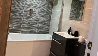 a bathroom with a bath tub and a sink and a bath tub at Mathew Street 1 bed apt sleeps 6 in Liverpool