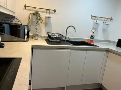 a kitchen with a sink and a microwave at Mathew Street 1 bed apt sleeps 6 in Liverpool