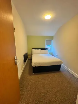 a bedroom with a bed and a television in it at The Charlton - Aparthotel in Blackpool