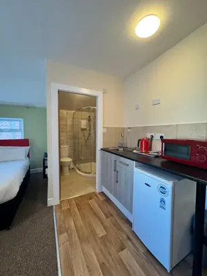 a kitchen with a sink and a shower in a room at The Charlton - Aparthotel in Blackpool