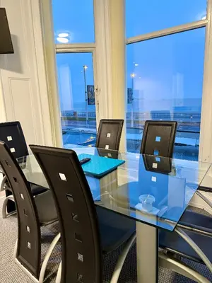 a conference room with a glass table and chairs at The Charlton - Aparthotel in Blackpool