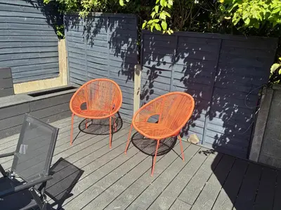 two orange chairs sitting on top of a deck at Modern and comfortable stay in Morecambe in Morecambe