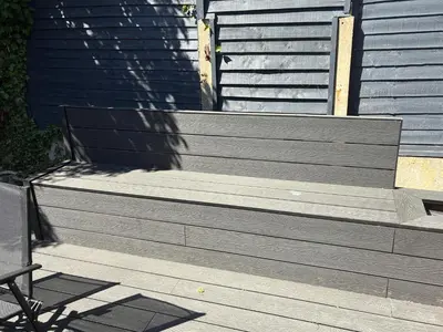 a wooden bench sitting on the side of a house at Modern and comfortable stay in Morecambe in Morecambe