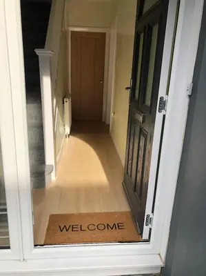 a hallway with a welcome mat in front of a door at Modern and comfortable stay in Morecambe in Morecambe