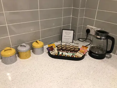 a tray of food on a counter next to a coffee maker at Modern and comfortable stay in Morecambe in Morecambe