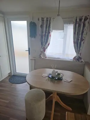 a living room with a table and a couch at Lytham Luxe 6 Birth Caravan in Weeton