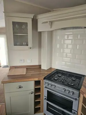 a kitchen with a stove and a counter top at Lytham Luxe 6 Birth Caravan in Weeton