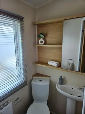 a bathroom with a toilet and a sink at Lytham Luxe 6 Birth Caravan in Weeton