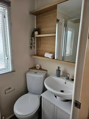 a bathroom with a white toilet and a sink at Lytham Luxe 6 Birth Caravan in Weeton