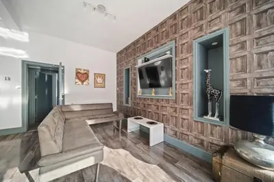 a living room with a couch and a tv at Spacious, Central Townhouse with Hot Tub & Free Parking in Lytham St Annes