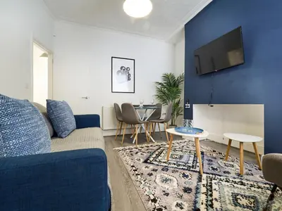 a living room with a couch and a table at Woodcroft House - Air Host & Stay - 4 Bedrooms in Liverpool