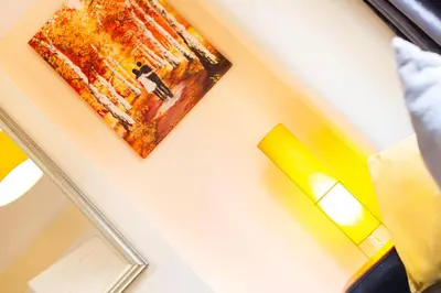 a painting hanging on a wall next to a lamp at Newly Launched 3 Bedroom House with Free Parking in Litherland