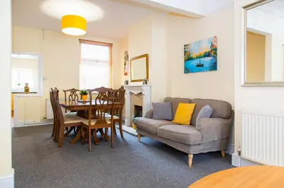 a living room with a couch and a table at Newly Launched 3 Bedroom House with Free Parking in Litherland