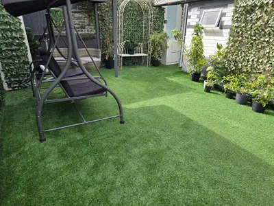 a garden with a chair on the grass at Ensuite room with private entrance and private garden in Blackpool