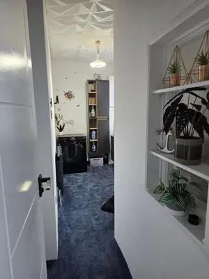 a hallway with a door open to a room with plants at Ensuite room with private entrance and private garden in Blackpool