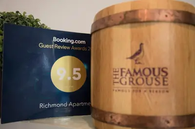a wooden barrel sitting next to a book at Richmond Apartment in Liverpool