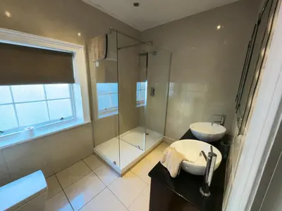 a bathroom with a shower and a sink at Richmond Apartment in Liverpool