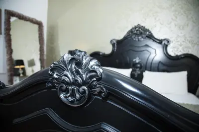 a black bed with a lion head on it at Richmond Apartment in Liverpool