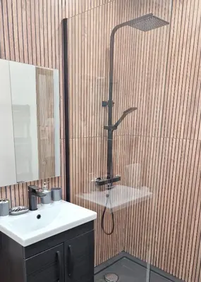 a bathroom with a shower and a sink at Historic 17th-Century Cottage with Hot Tub in Charming Heysham in Heysham