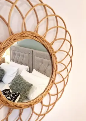 a wicker rattan basket with pillows on a bed at Historic 17th-Century Cottage with Hot Tub in Charming Heysham in Heysham