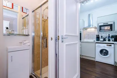 a white kitchen with a washer and dryer at Stylish 1-Bed Apartment in St. Annes in Lytham St Annes