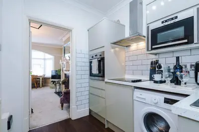 a white kitchen with a washer and dryer in it at Stylish 1-Bed Apartment in St. Annes in Lytham St Annes