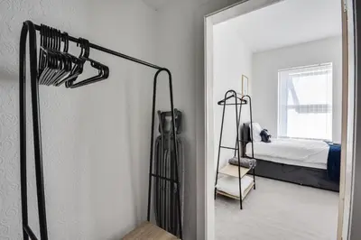 a room with a bedroom with a bed and a mirror at Stay With Alexandra 2 Free Parking - high speed Free Wifi close to stadiums in Liverpool