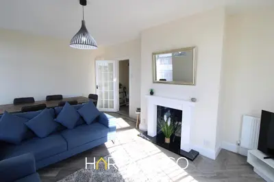 a living room with a blue couch and a fireplace at Light House View in Fleetwood