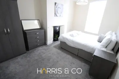 a bedroom with a bed and a tv and a dresser at Light House View in Fleetwood